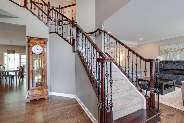 2550 Bayswater Cir, Gurnee, IL 60031 - staircase with wood finished floors, baseboards, a fireplace, recessed lighting, and a high ceiling