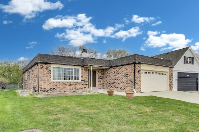 single story home featuring brick siding, a garage, a front yard, and concrete driveway