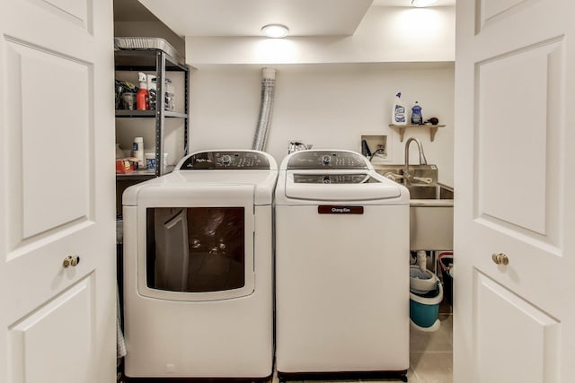 clothes washing area with tile patterned flooring, laundry area, and washing machine and clothes dryer