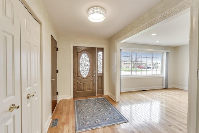 entrance foyer featuring baseboards, light wood finished floors, and visible vents