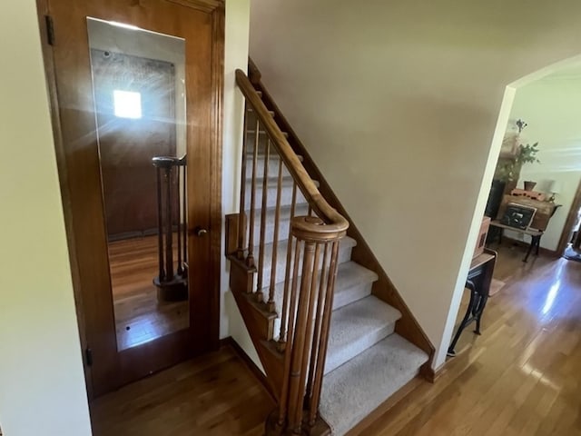 stairway featuring wood finished floors