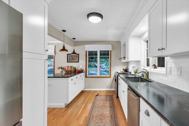 902 W William St, Champaign, IL 61821 - kitchen featuring stainless steel appliances, a sink, white cabinets, baseboards, and ornamental molding