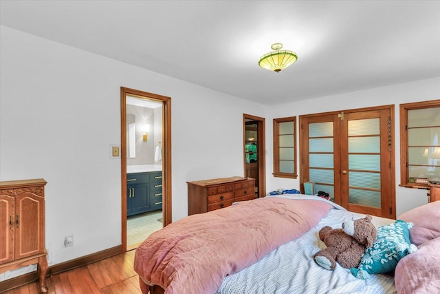 902 W William St, Champaign, IL 61821 - bedroom featuring light wood-style flooring, baseboards, and ensuite bath