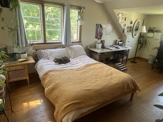 bedroom featuring wood-type flooring and baseboards