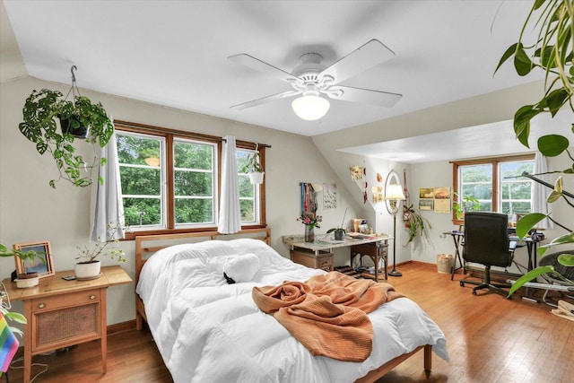902 W William St, Champaign, IL 61821 - bedroom with wood finished floors, a desk, lofted ceiling, ceiling fan, and baseboards