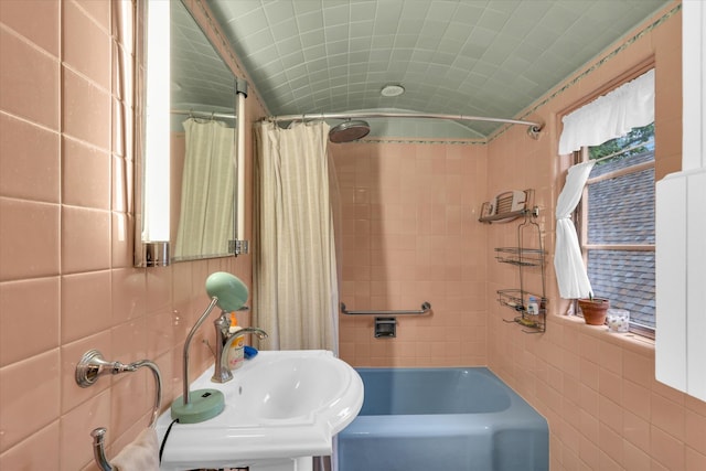 902 W William St, Champaign, IL 61821 - bathroom featuring tile walls, a sink, and shower / bath combo with shower curtain