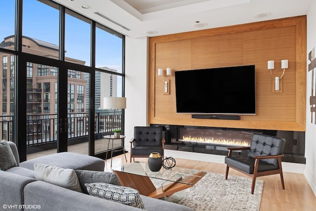400 W Ontario St Unit 1801, Chicago, IL 60654 - living room with wood finished floors, expansive windows, a tray ceiling, and baseboards