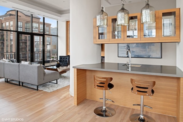 400 W Ontario St Unit 1801, Chicago, IL 60654 - bar featuring wood finished floors, a sink, and decorative light fixtures