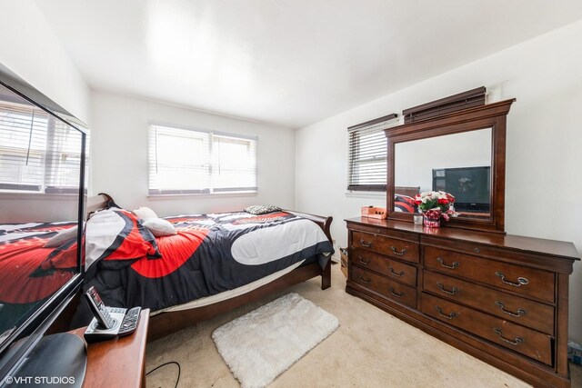 bedroom featuring light carpet