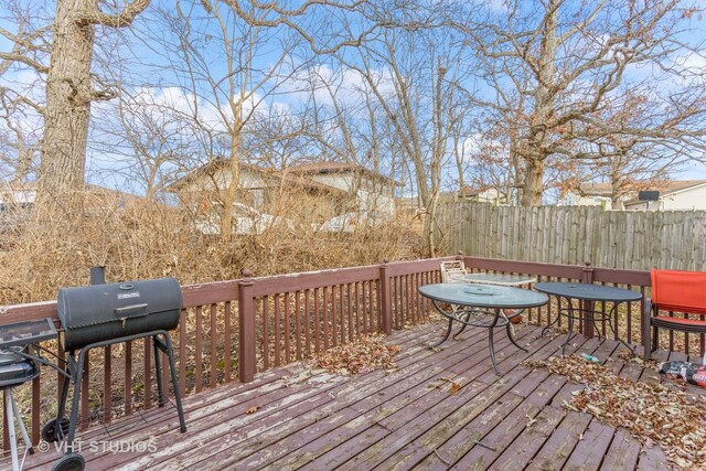 wooden deck with grilling area and fence