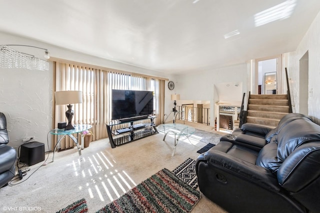 carpeted living area featuring stairway