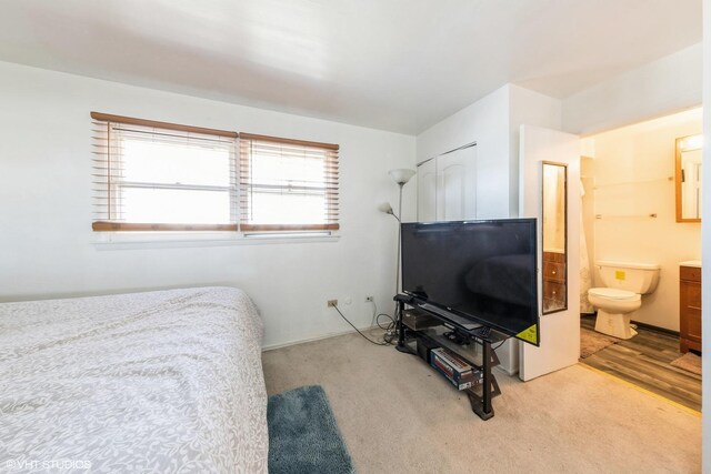 carpeted bedroom with ensuite bath