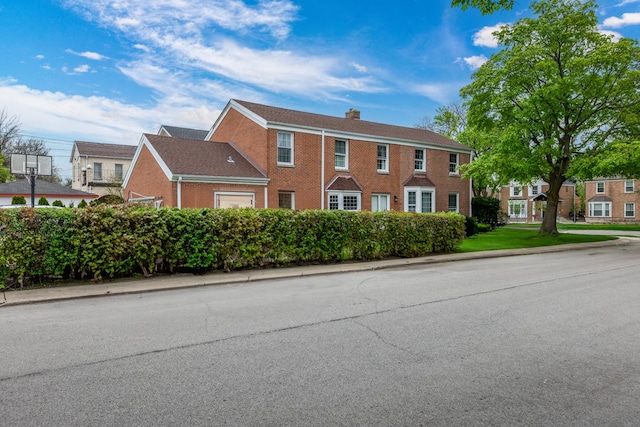 6700 N Monticello Ave, Lincolnwood, IL 60712 - colonial-style house featuring a chimney and brick siding