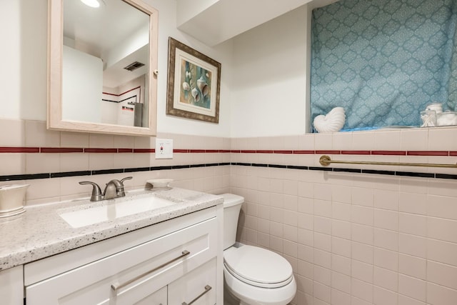 6700 N Monticello Ave, Lincolnwood, IL 60712 - bathroom with visible vents, tile walls, wainscoting, vanity, and toilet