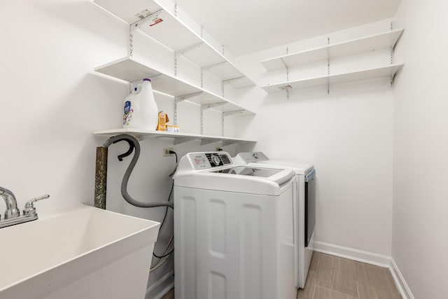 6700 N Monticello Ave, Lincolnwood, IL 60712 - clothes washing area featuring baseboards, laundry area, washing machine and dryer, and a sink