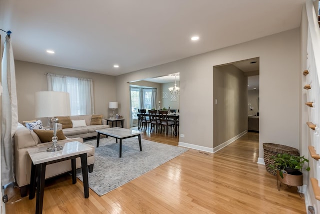 6700 N Monticello Ave, Lincolnwood, IL 60712 - living area with light wood-style floors, baseboards, an inviting chandelier, and recessed lighting