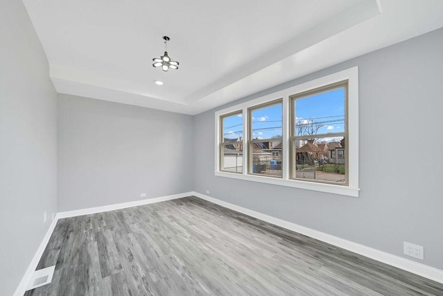 7315 S California Ave, Chicago, IL 60629 - spare room featuring wood finished floors, baseboards, recessed lighting, a tray ceiling, and a notable chandelier