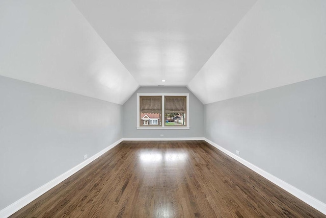 7315 S California Ave, Chicago, IL 60629 - additional living space with baseboards, vaulted ceiling, and dark wood-style floors