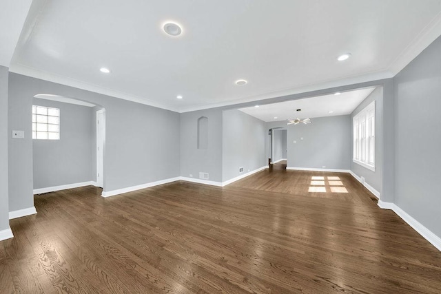 7315 S California Ave, Chicago, IL 60629 - unfurnished living room featuring arched walkways, baseboards, ornamental molding, and a healthy amount of sunlight