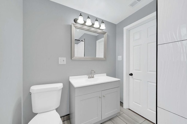 7315 S California Ave, Chicago, IL 60629 - bathroom with visible vents, toilet, and vanity