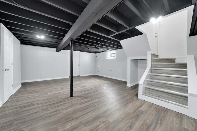 7315 S California Ave, Chicago, IL 60629 - below grade area featuring stairway, baseboards, and wood finished floors