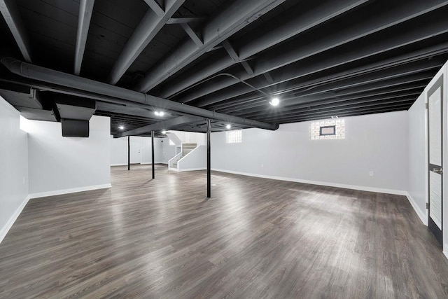 7315 S California Ave, Chicago, IL 60629 - below grade area with baseboards, wood finished floors, and stairway