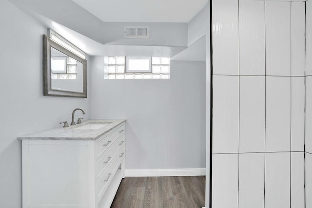 7315 S California Ave, Chicago, IL 60629 - bathroom featuring baseboards, visible vents, wood finished floors, and vanity