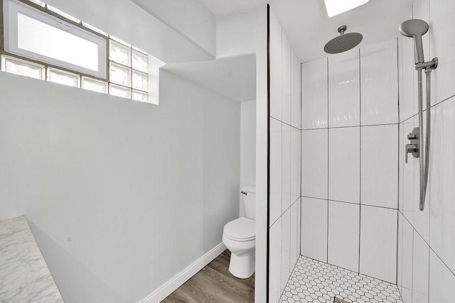 7315 S California Ave, Chicago, IL 60629 - bathroom with toilet, a tile shower, and wood finished floors