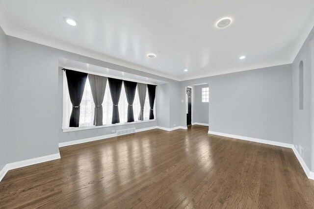 7315 S California Ave, Chicago, IL 60629 - unfurnished living room with arched walkways, baseboards, visible vents, and wood finished floors