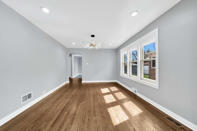 7315 S California Ave, Chicago, IL 60629 - interior space featuring arched walkways, baseboards, dark wood-style floors, and visible vents
