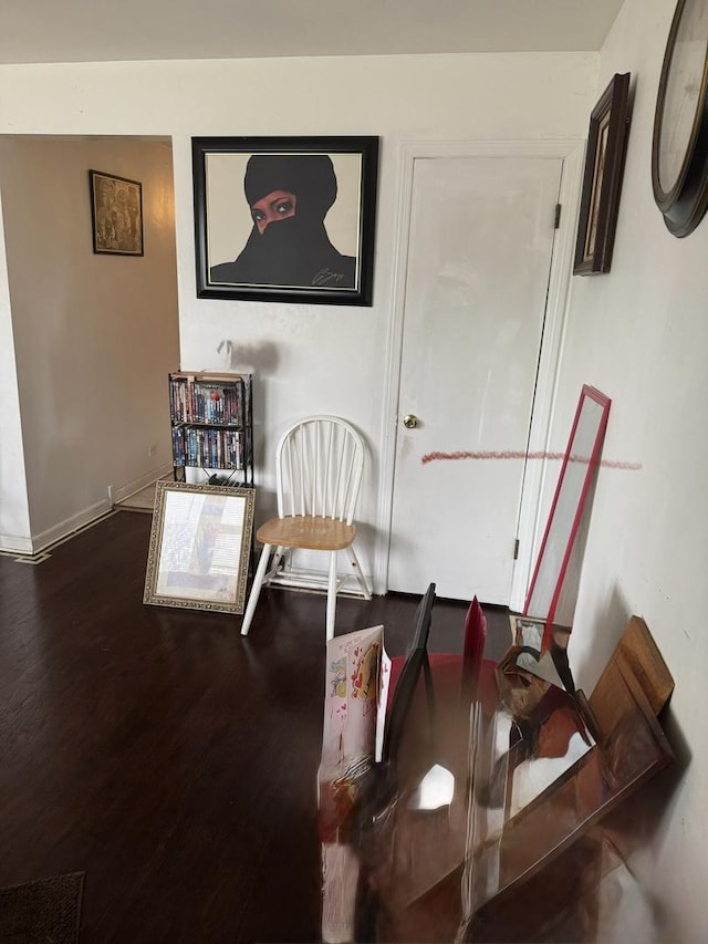 interior space featuring baseboards and wood finished floors