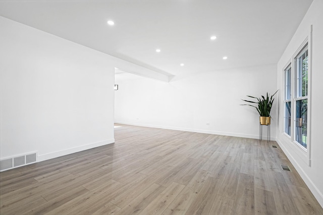unfurnished room featuring light wood-style floors, recessed lighting, and baseboards