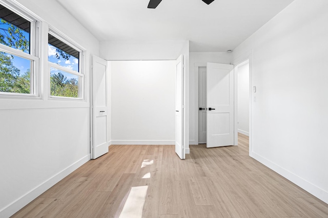 unfurnished bedroom featuring light wood finished floors, baseboards, and ceiling fan