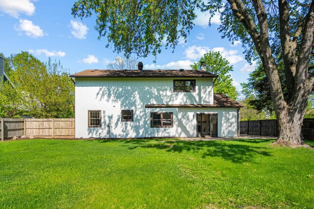 rear view of property featuring a chimney