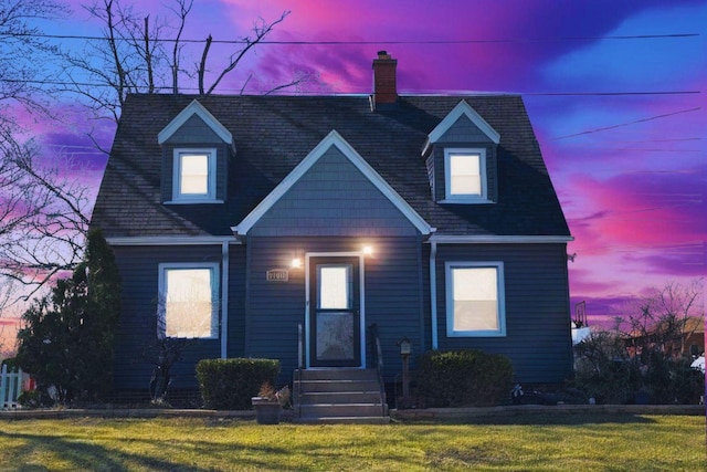 view of front of house with a front yard and a chimney