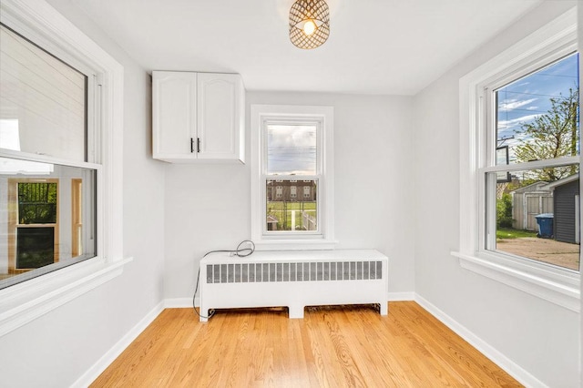 12540 S Tripp Ave, Alsip, IL 60803 - bedroom with radiator heating unit, multiple windows, and baseboards