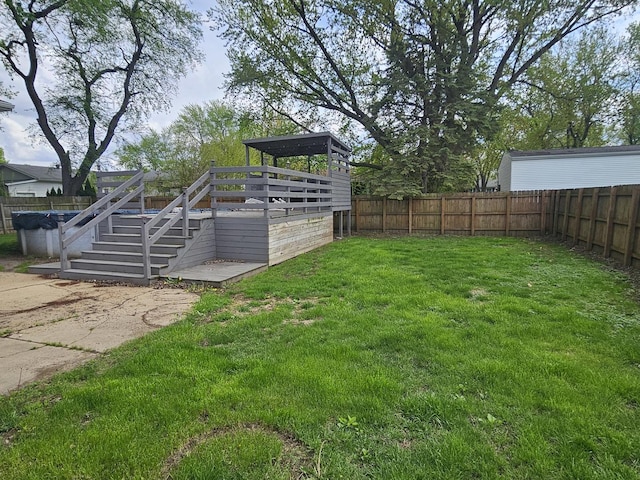 1208 Minkel St, Rock Falls, IL 61071 - view of yard featuring stairway, a wooden deck, and a fenced backyard