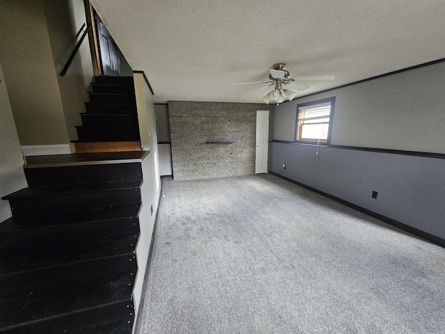 1208 Minkel St, Rock Falls, IL 61071 - unfurnished living room featuring stairs, baseboards, ceiling fan, a textured ceiling, and carpet flooring