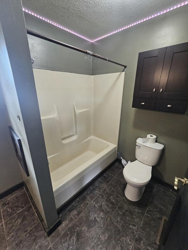 1208 Minkel St, Rock Falls, IL 61071 - bathroom with baseboards, shower / bathing tub combination, toilet, and a textured ceiling