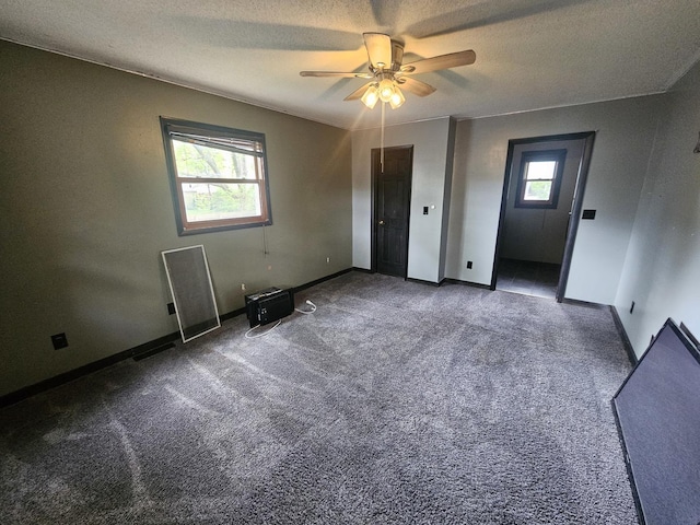 1208 Minkel St, Rock Falls, IL 61071 - unfurnished bedroom with a textured ceiling, baseboards, a ceiling fan, and carpet
