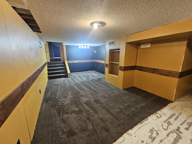 1208 Minkel St, Rock Falls, IL 61071 - finished below grade area featuring stairway, a textured ceiling, visible vents, and carpet