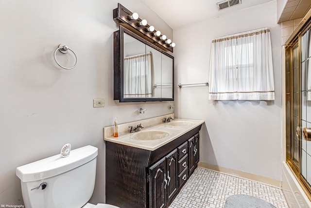 bathroom with a sink, toilet, double vanity, and visible vents