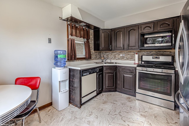 kitchen featuring a sink, appliances with stainless steel finishes, dark brown cabinetry, and light countertops
