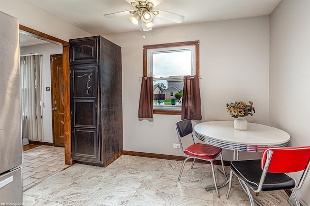dining room featuring ceiling fan and baseboards