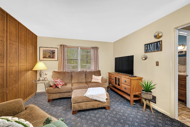 living room featuring carpet flooring and baseboards