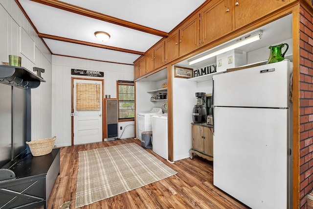 kitchen featuring freestanding refrigerator, open shelves, wood finished floors, brown cabinets, and washer and clothes dryer