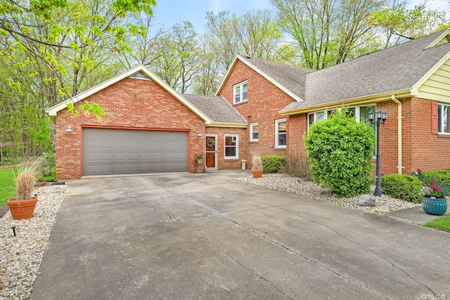 view of front of home featuring driveway, brick siding, and a shingled roof