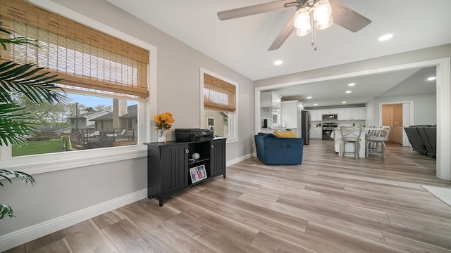 interior space featuring light wood finished floors, baseboards, a ceiling fan, and recessed lighting