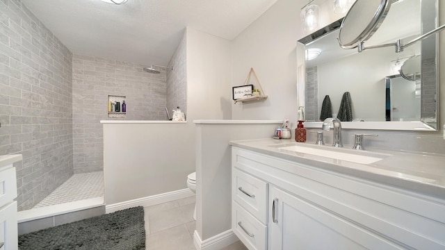 full bath with toilet, tile patterned flooring, vanity, and walk in shower