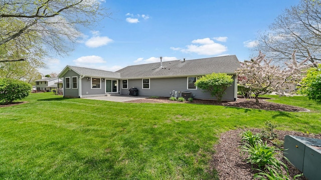 rear view of property with a patio area and a lawn